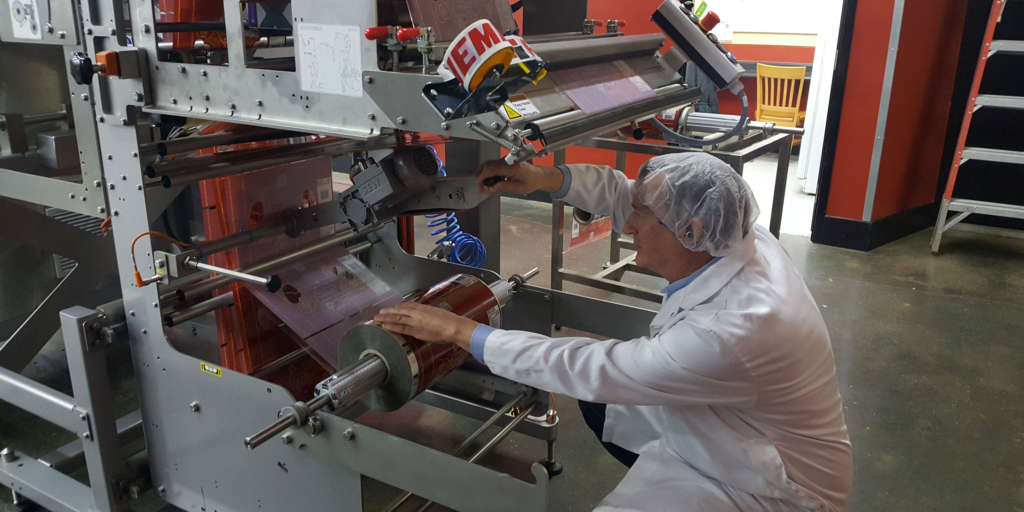technician doing service and repair on a production machine and equipment